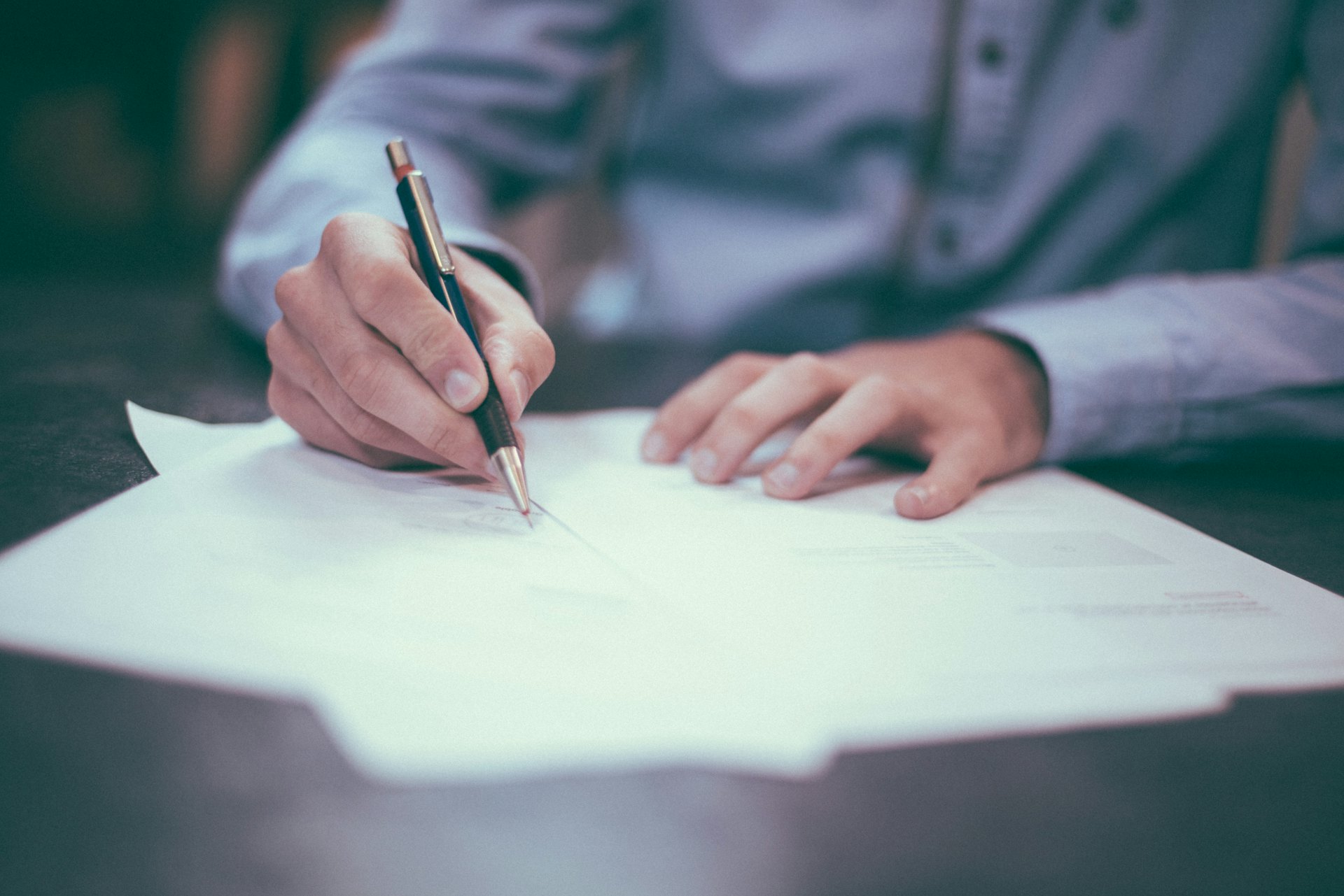 A client reviewing and signing property documents